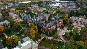 An aerial view of the Holy Cross campus that is centered on the clocktower of O’Kane Hall.