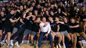 Holy Cross Athletic Director Kit Hughes takes a selfie with a large group of student athletes.