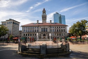 A fountain in downtown Worcester, MA with City Hall in the background.